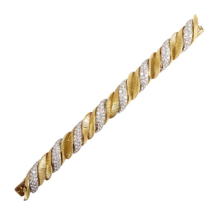 Yellow gold and diamond leaf scroll strap bracelet, slightly bombe form alternating pave diamond scrolls with reeded gold leaf scrolls